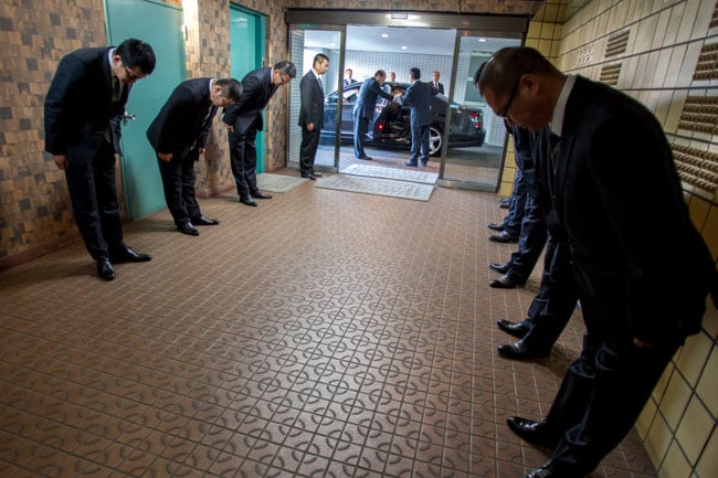 Yakuza bowing respectfully, photographed by Christopher Jue for The Times of London.