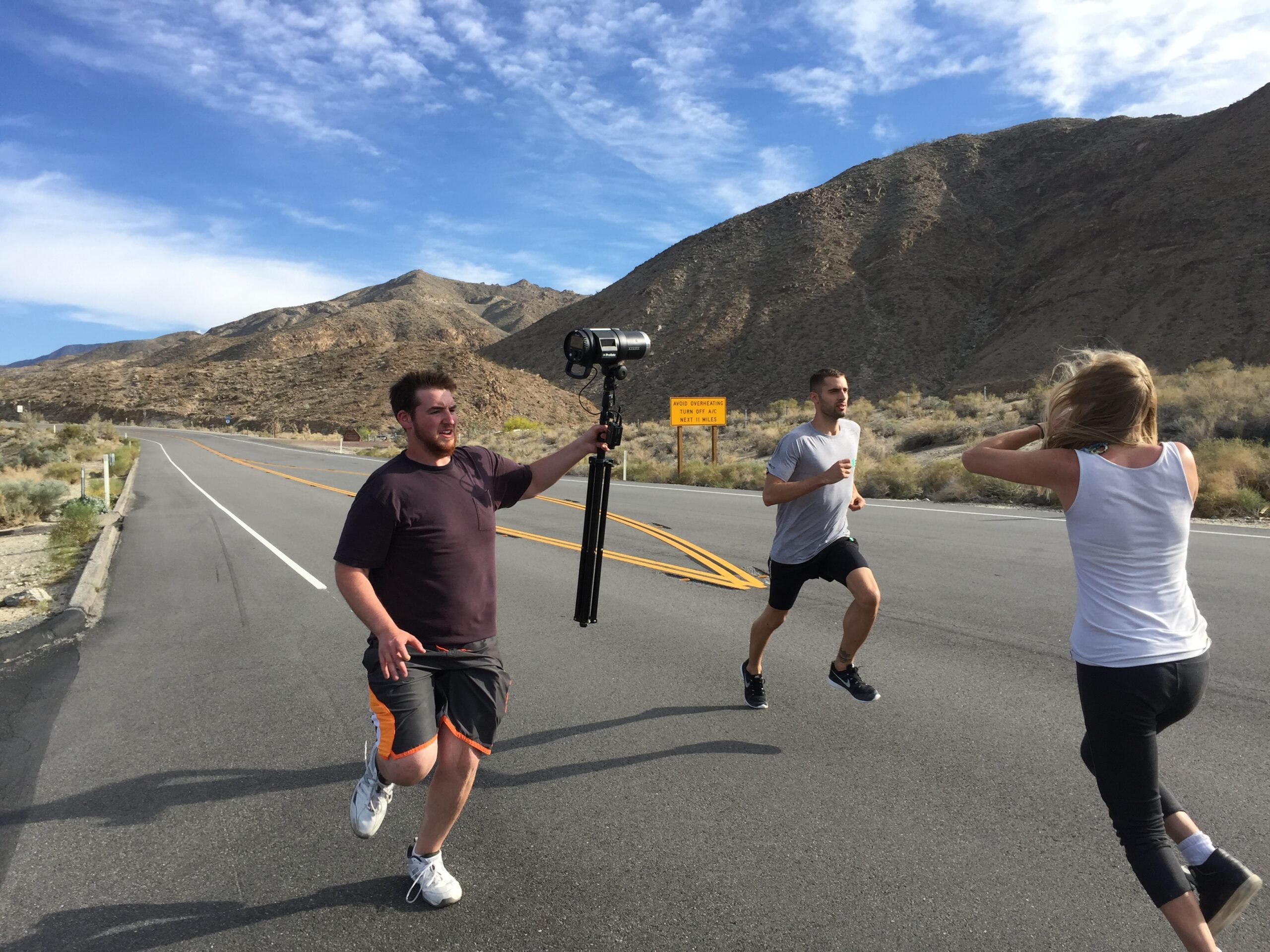 BTS shot showing of a man running while being photographed