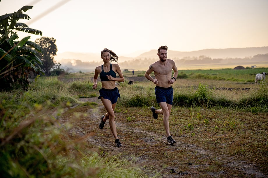 Ian MacLellans photo of man and woman wearing Janji running on a trail at sunrise