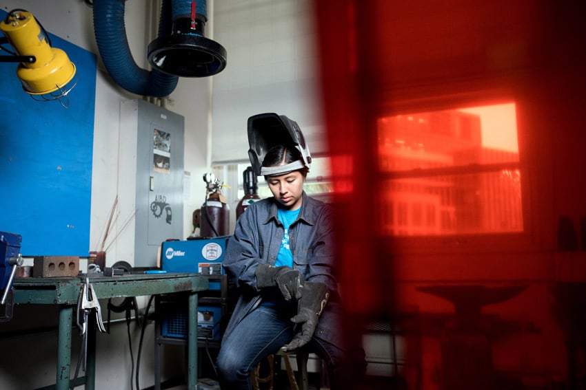 A portrait by Ian MacLellan of a woman donning protective work equipment.