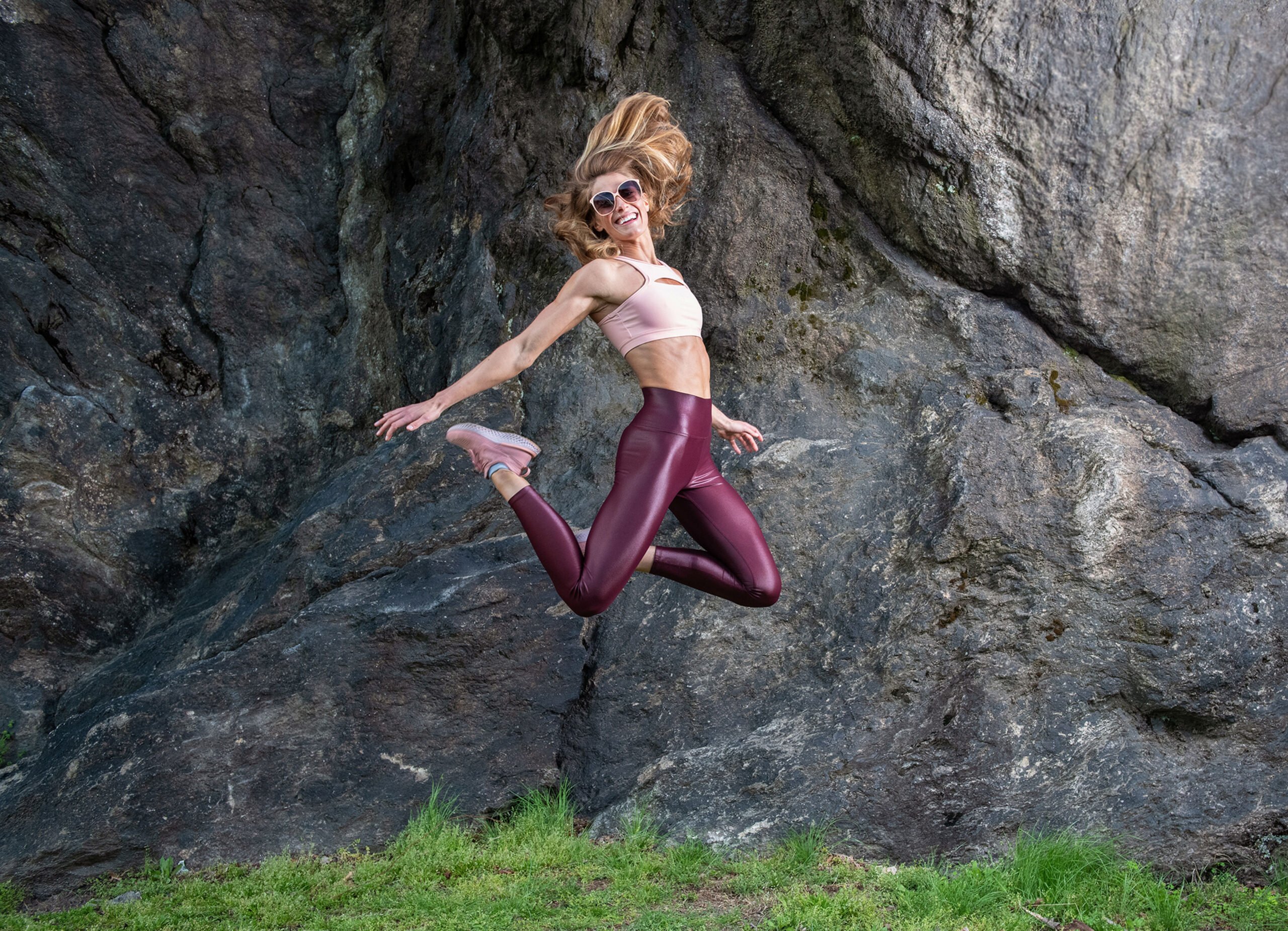 Julia Lehman catches Cat in mid-leap in front of the rocks while wearing sunglasses