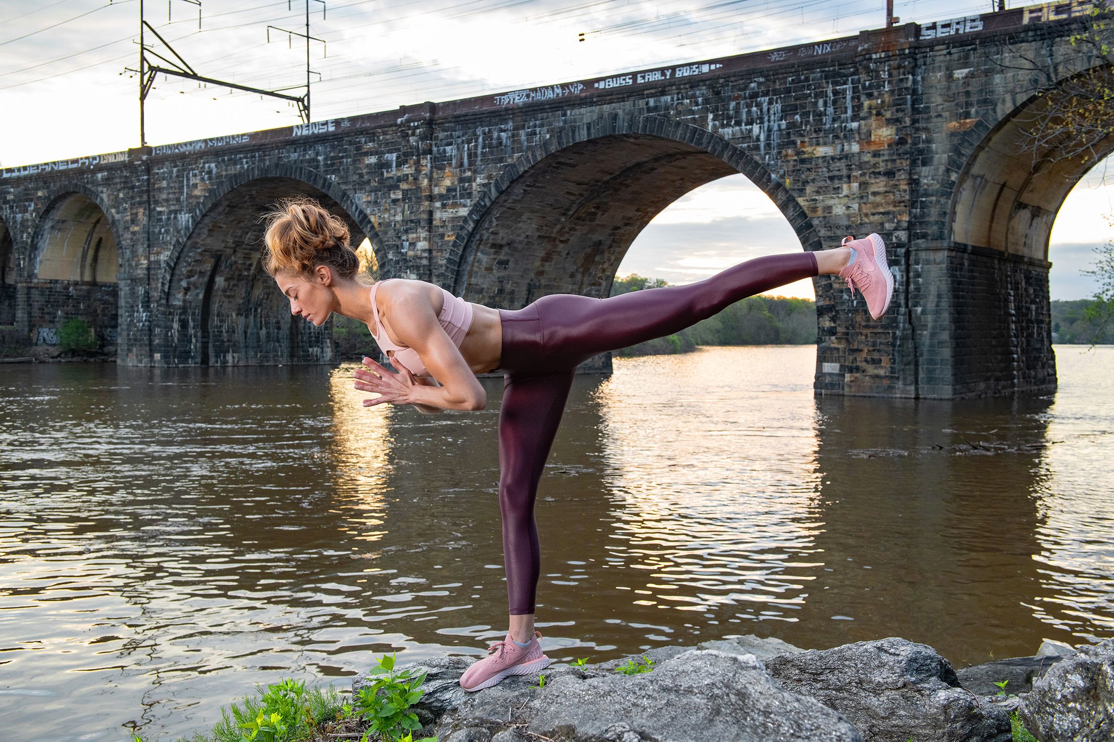 Julia Lehman has Cat perform a yoga pose on the bank of the Schuylkill River 