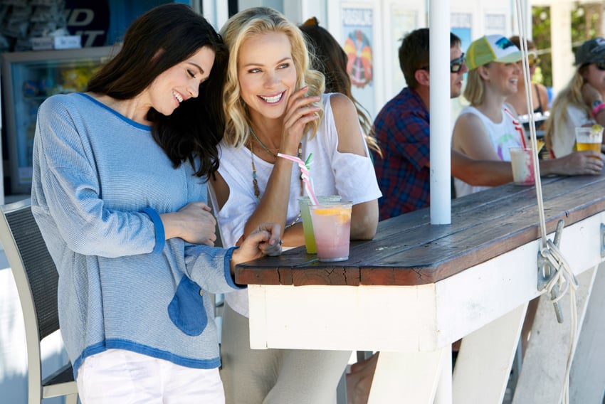 Two ladies enjoy refreshing cold drinks on a hot day. Photo by Jason Innes.