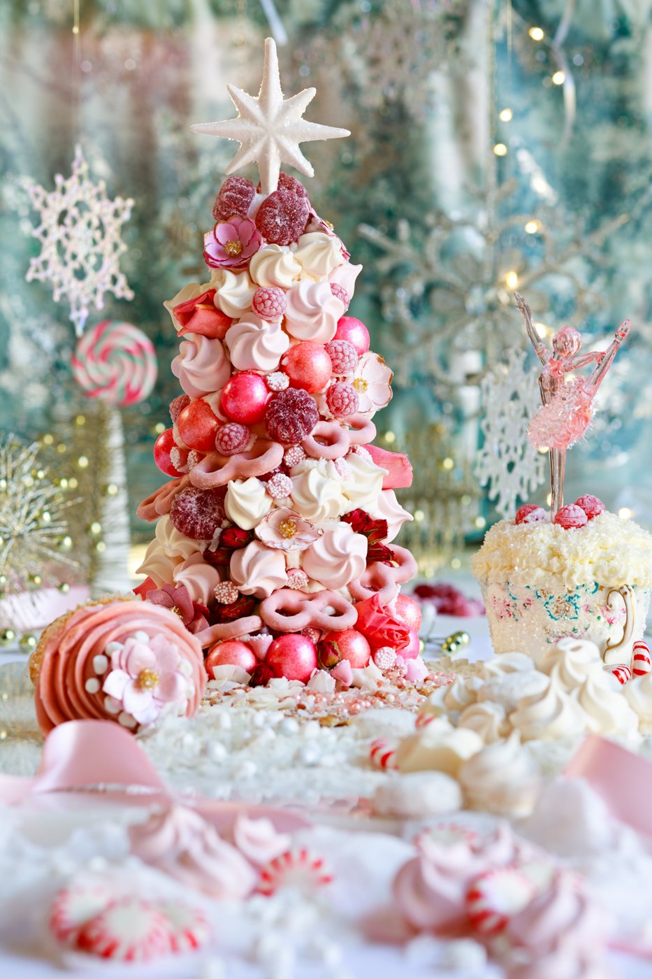 An edible candy Christmas tree with many shades of pink, red, and white