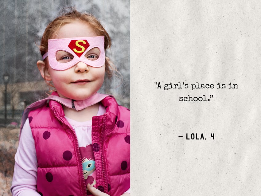 Natalia Weedy's portrait of a young girl with red hair wearing a pink felt superhero's mask with a Superman "S" logo. 