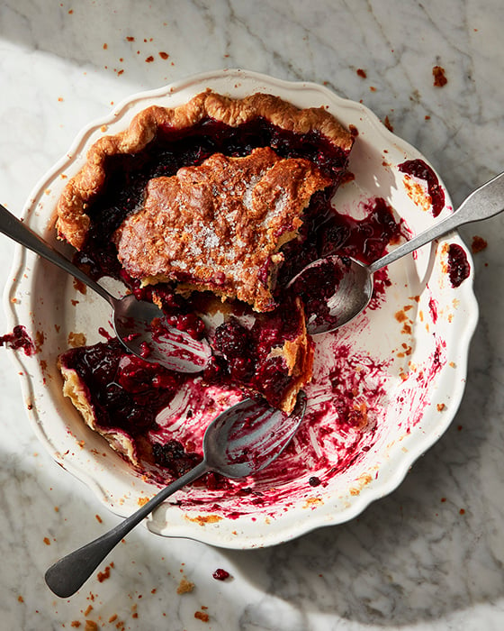 Mark Weinbergs photo of a mostly devoured pie with three spoons that have been scraping the berry pie out of the pie plate