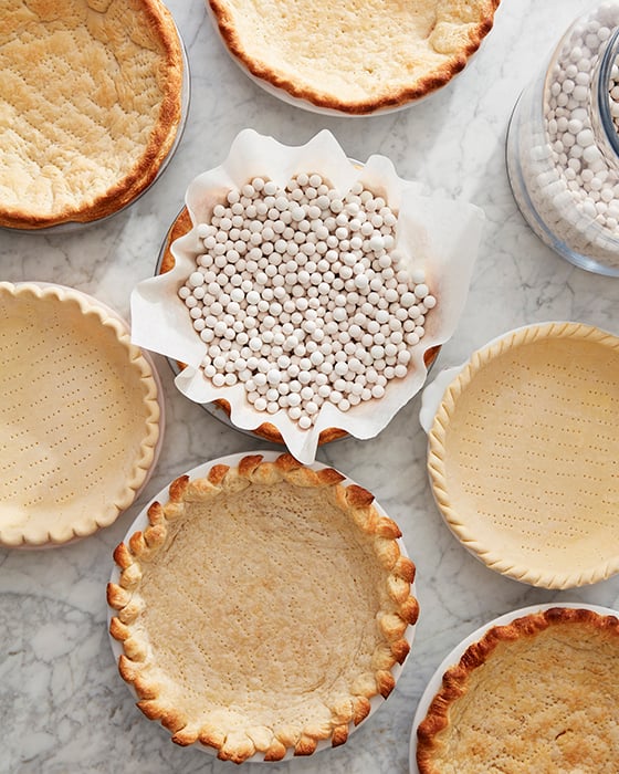 Mark Weinberg photographs pie crusts some filled with baking weights others empty with all different designs and bakes