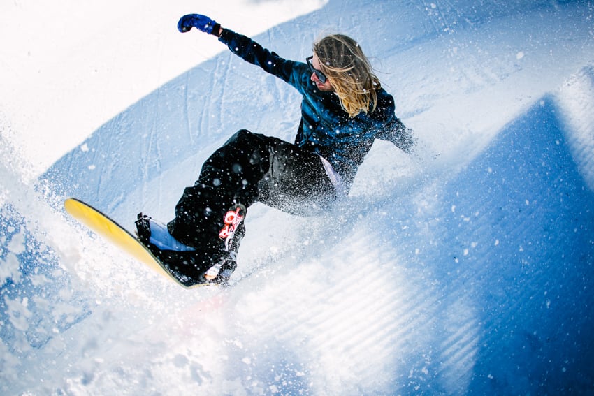 An athlete snowboarding photographed by Adam Moran.