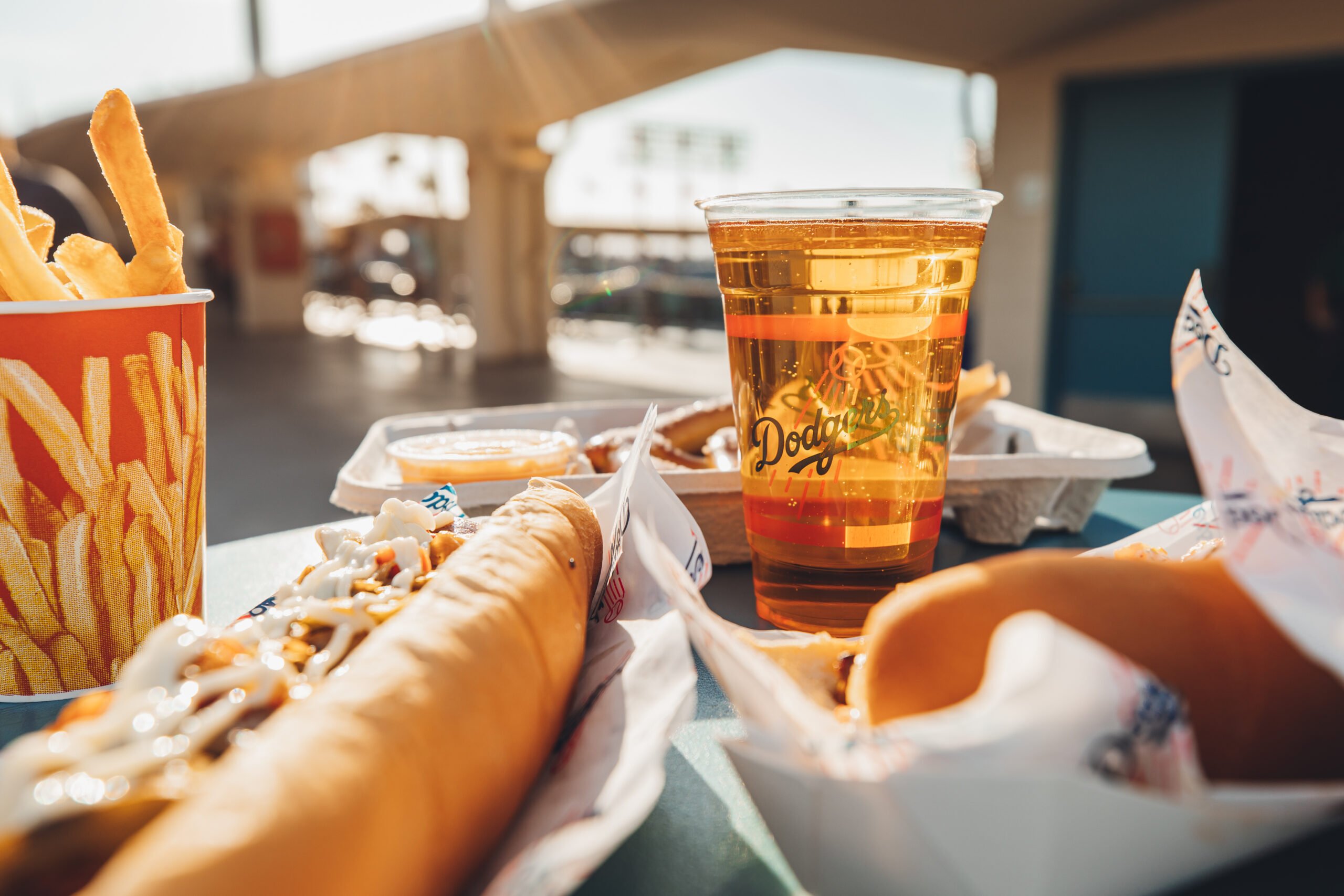 Krystal Thompson's close up of a couple dogs, a cup of fries, and a beer at Dodgers stadium.