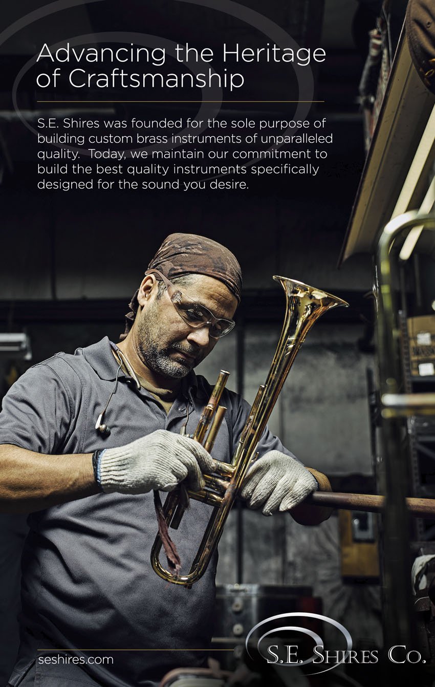 A tear sheet by Doug Levy for S.E. Shires featuring a photo of a craftsman working on a brass trumpet. He wears protective goggles, gloves, and a brown handkerchief on his head.