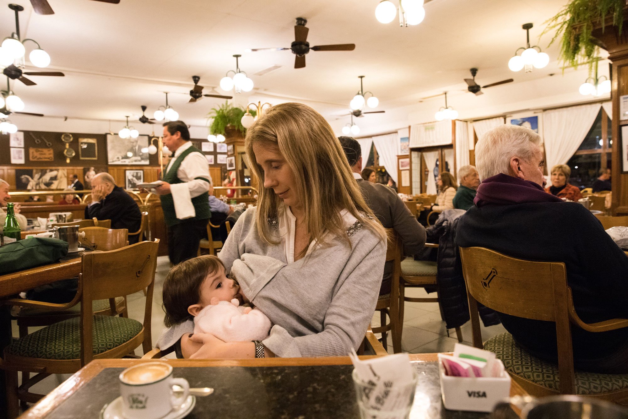 Tina Boyadjieva photographs Silvia in Argentina as she breastfeeds in a crowded cafe for Lansinoh USA