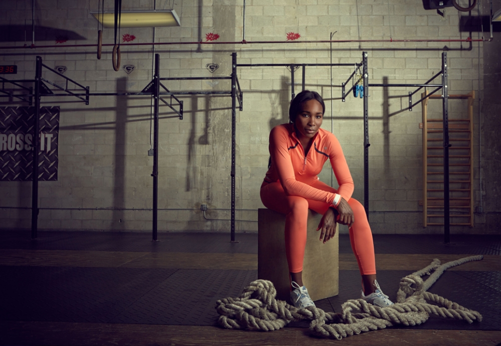 Venus Williams sits on a box in a gym in a red track suit in this photo by Mary Beth Koeth.