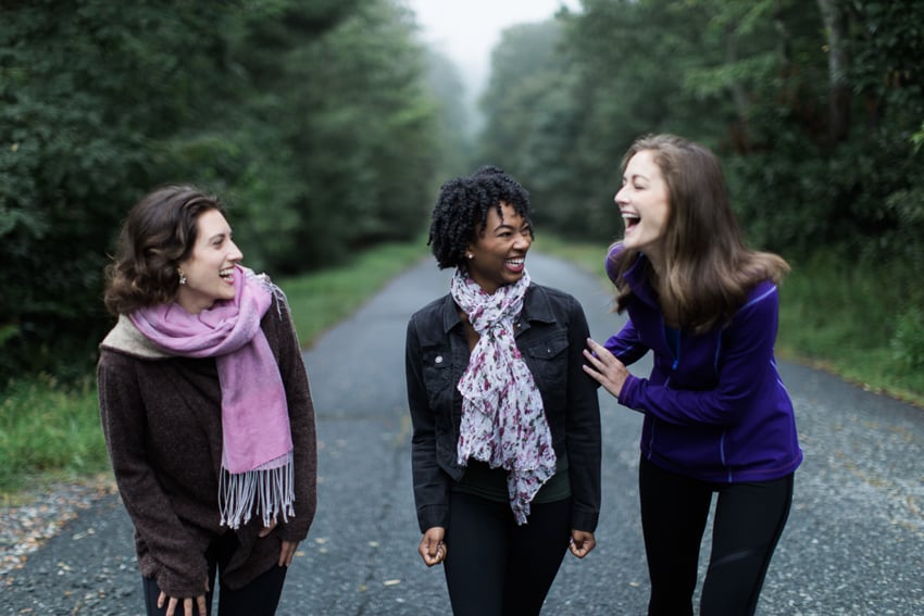 Photo of three women laughing and walking down a road by Nashville photographer Abigail Bobo