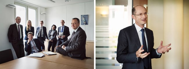Corporate photography showing staff circled around a desk as they look into the camera (left); portrait of a man mid-motion, holding out his hands (right)