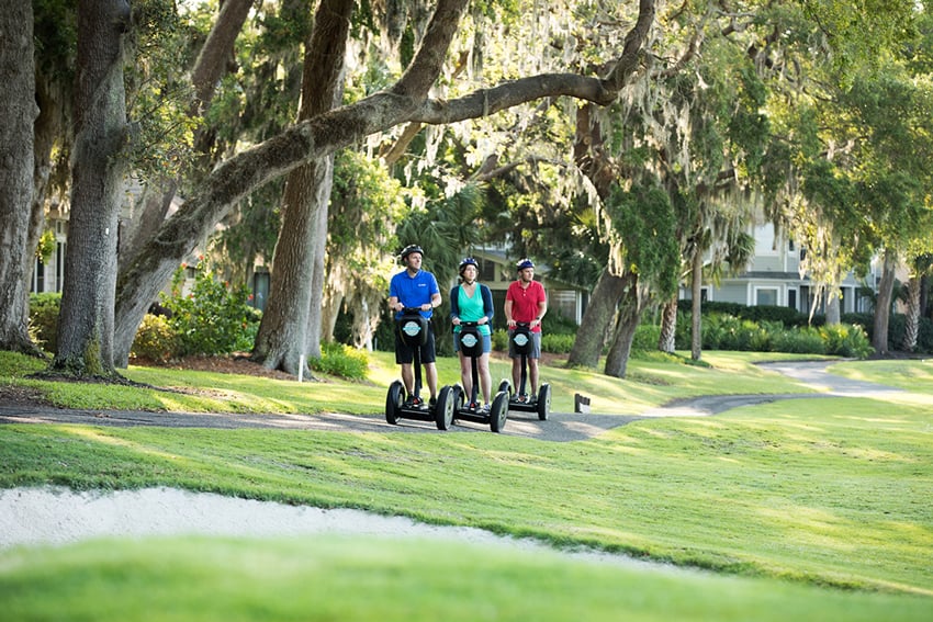 A photo of a group of people riding segways through a park. Photo by Amy Mikler.