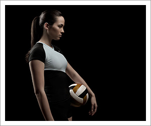 Portrait of an athlete holding a volleyball by Andrew Maguire