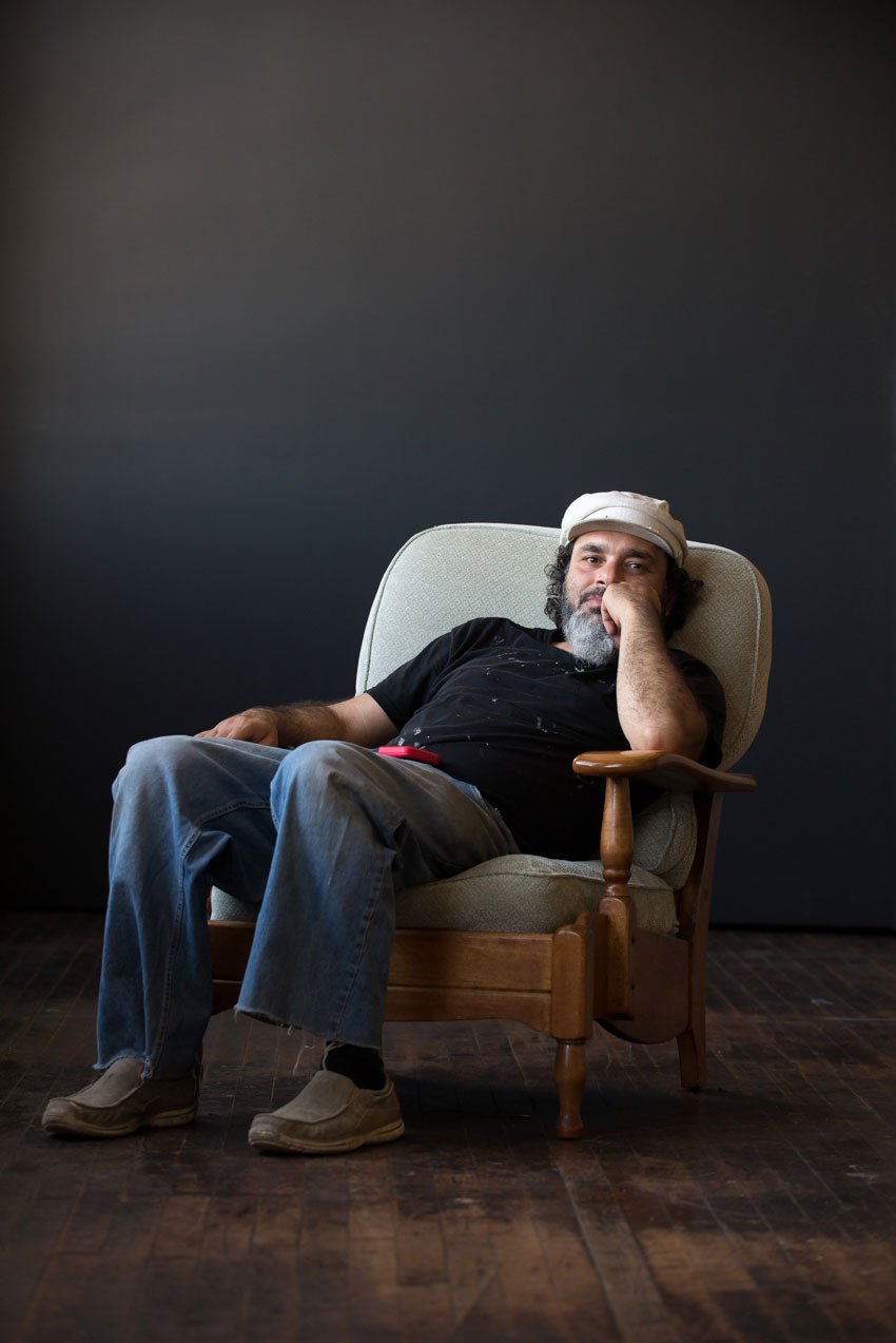 Photographer of a man sitting in a chair.
