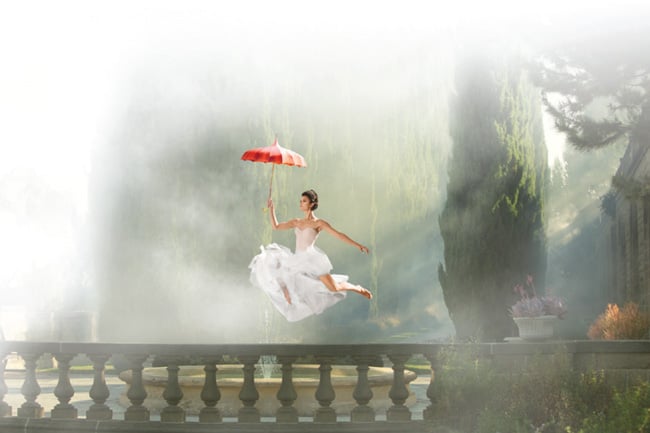 A ballerina floating through a garden 