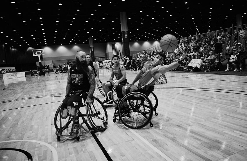 Injured veterans in wheelchairs playing basketball, photo by Darren Hauck.