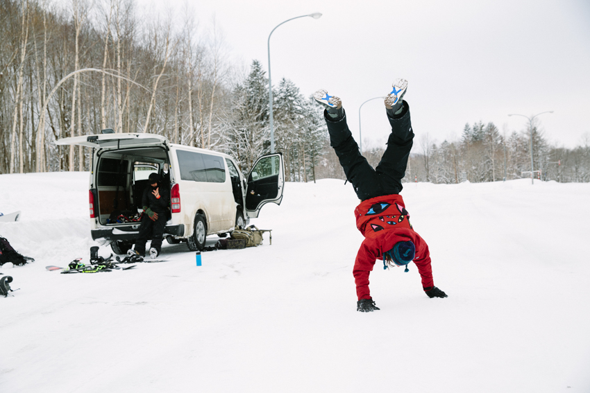 Person doing cartwheels in the snow photographed by Adam Moran.
