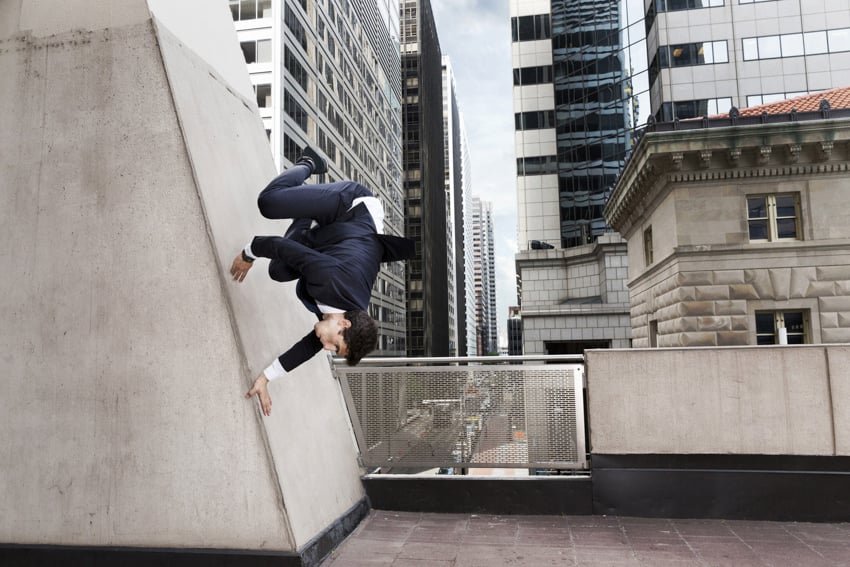 Athlete dressed in formal wear jumping from a wall shot by Ben Franke.