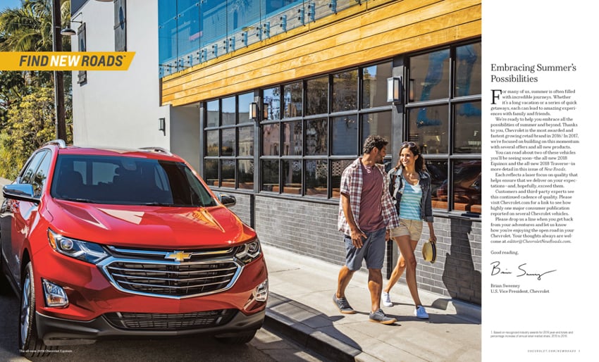A tear sheet by photographer Erik Isakson for Chevrolet's New Roads Magazine featuring a red Chevrolet SUV and a man and a woman smiling at each other while walking past it.