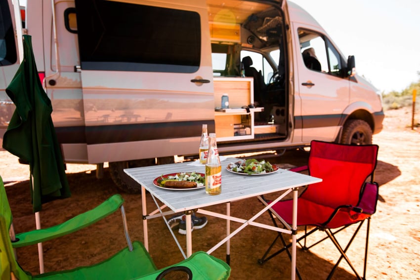 Table set for two outside Scott Gable's camper van on trip dubbed The Big Scout