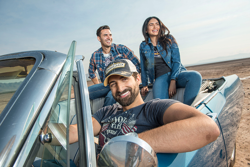 Photographer Jacob Kepler's photo for Goodyear Tire & Rubber Company.  the photo features three people in a convertible smiling into the distance. They all wear Goodyear brand t-shirts.