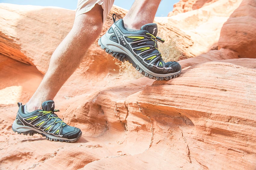 Photographer Jacob Kepler's photo for Goodyear Tire & Rubber Company.  The photo features a person's feet in Goodyear brand sneakers climbing on terracotta-colored rocks.