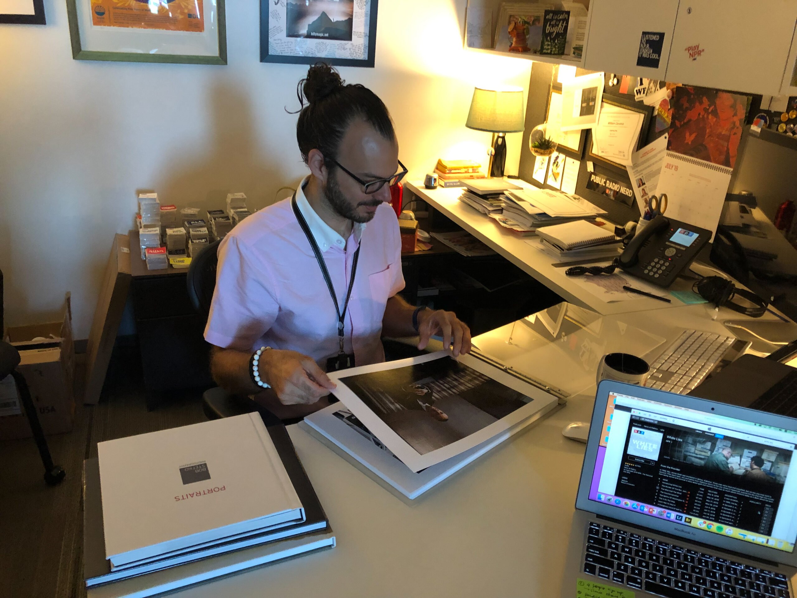 NPR's Creative Director Billy Candela looking at our portrait portfolios