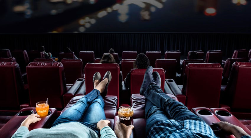 John Fulton's photograph of people lounging while watching a movie in the theater.