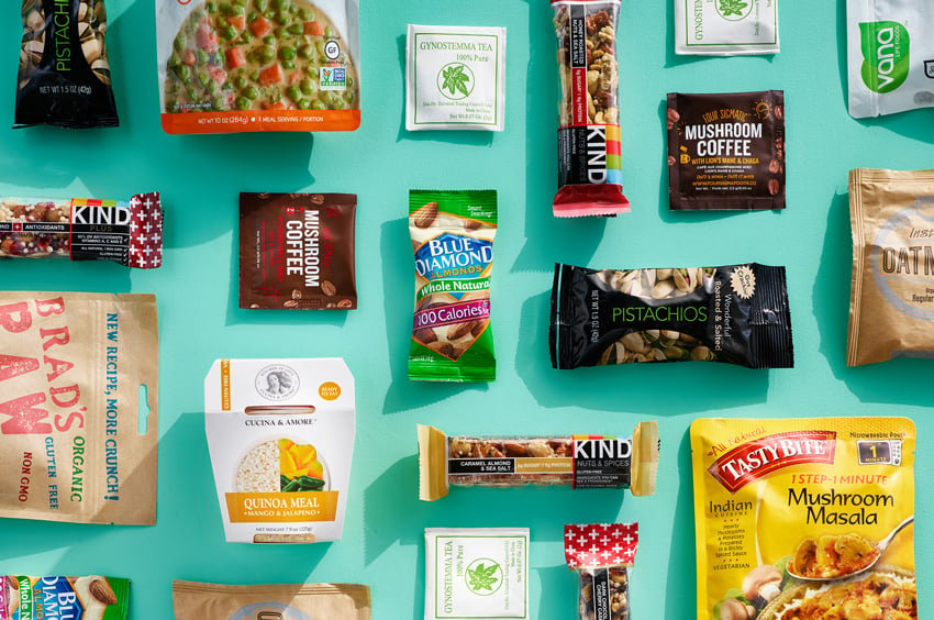 Kyle Dreier's photograph for Lifebox of a flat lay of snacks on a teal surface.