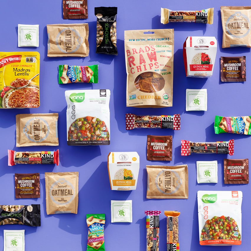 Kyle Dreier's photograph for Lifebox of a flat lay of packaged snacks on a lavender surface.