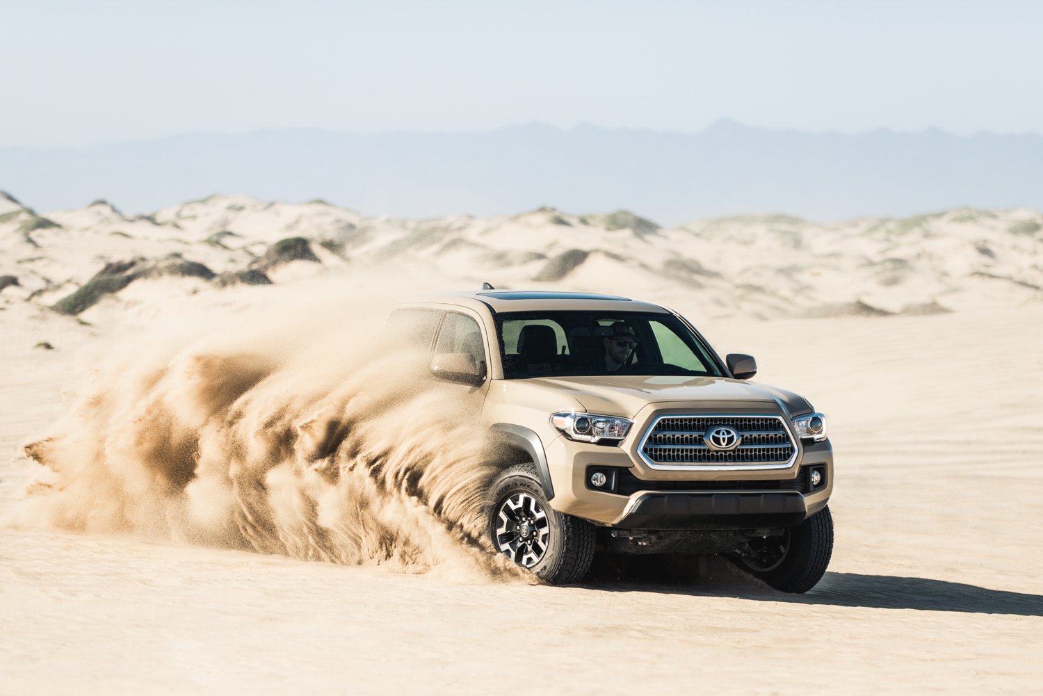 The Toyota Tacoma driving through the desert by Mark Skovorodko.