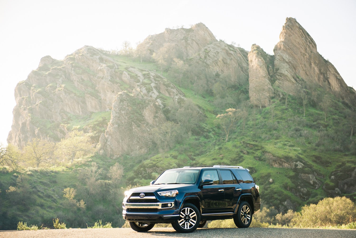 Toyota 4Runner parked in front of a beautiful, grassy rock structure, photo by Mark Skovorodko.