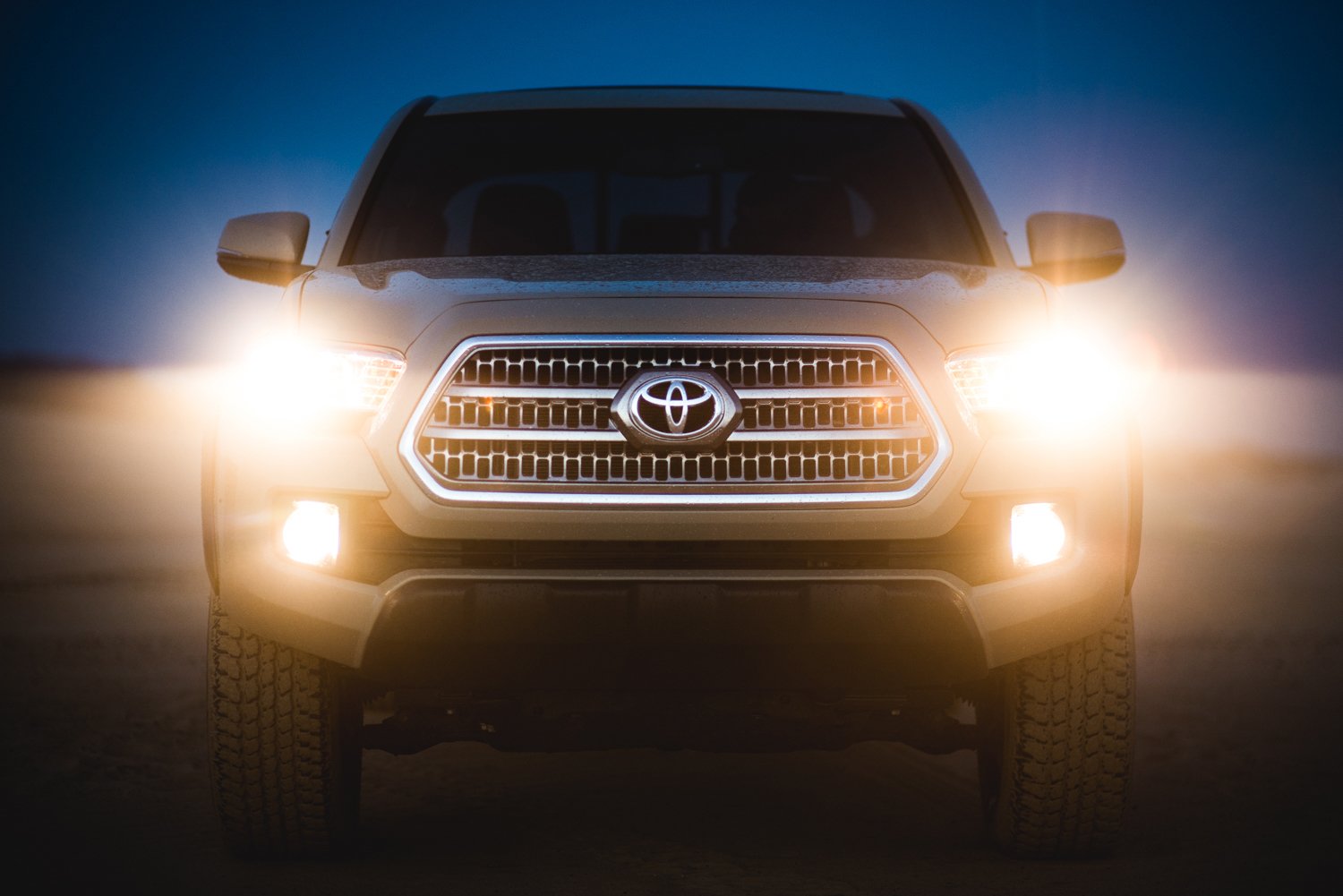 Front of a toyota 4Runner with it's headlights turned up, photo by Mark Skovorodko.