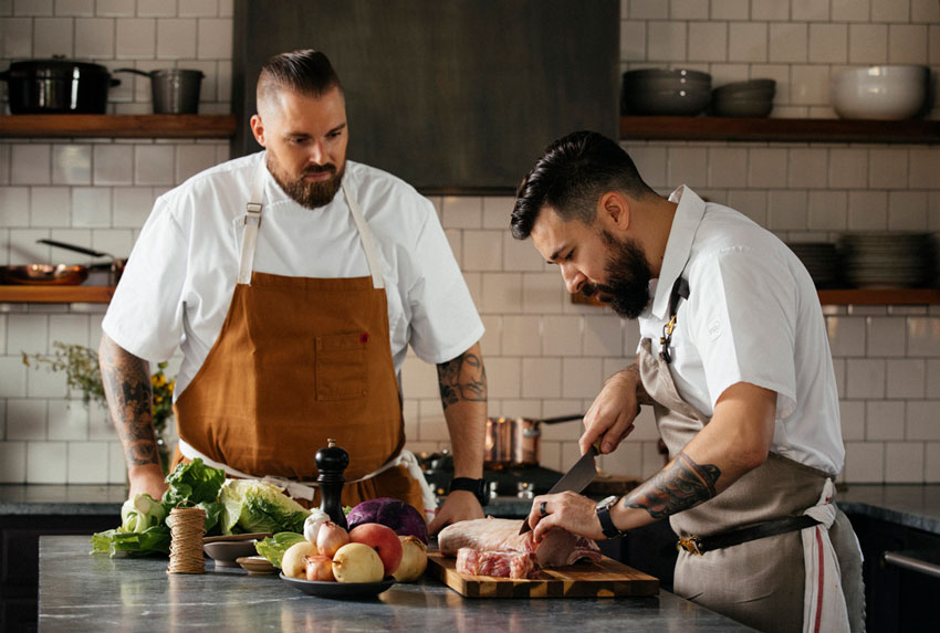 Two chefs preparing food by Nader Khouri for Fairmont Hotel.