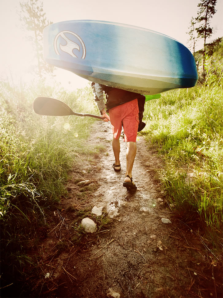 Andrew Maguire photo of a man hiking with a kayak