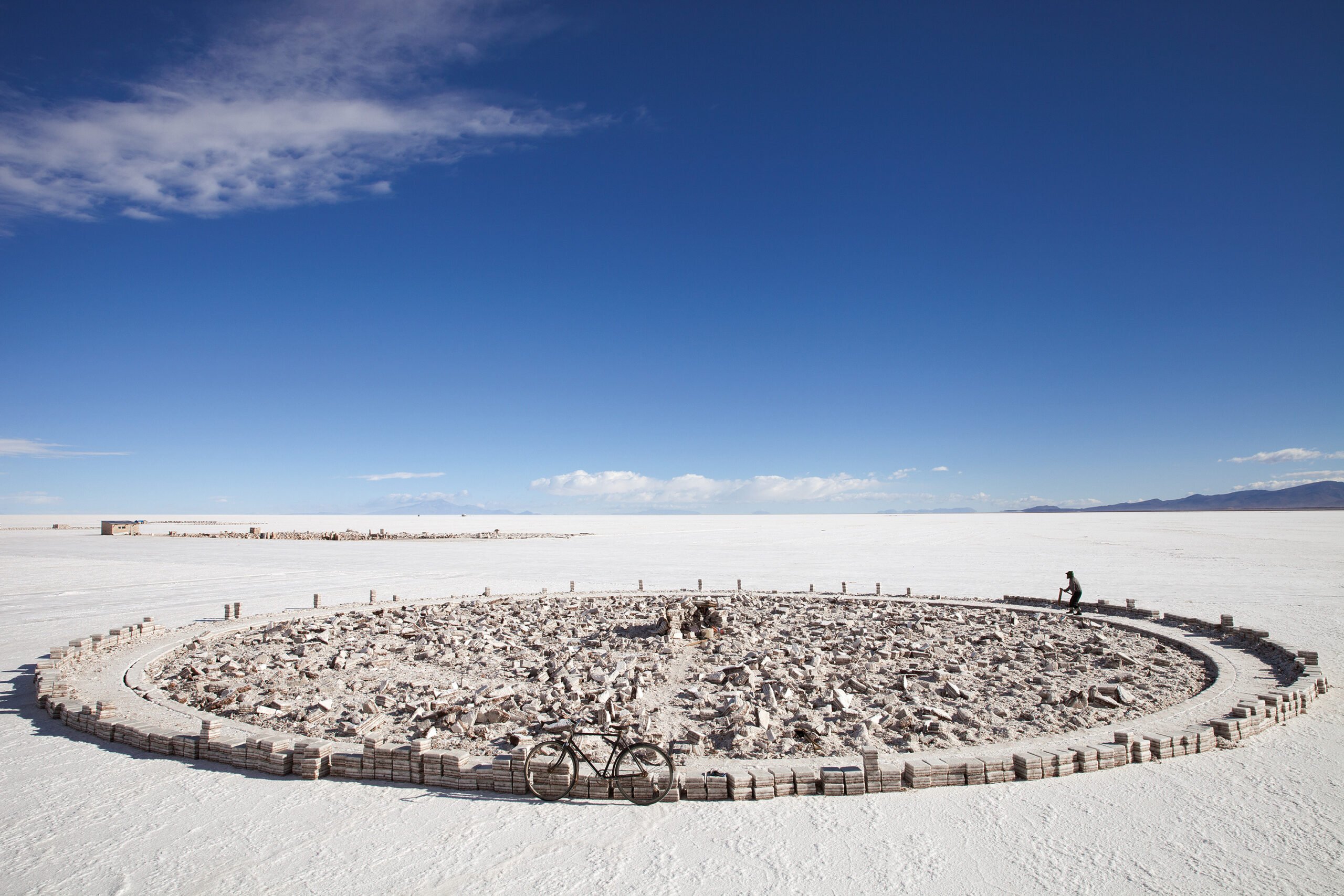 Someone working on a salt flat, photo by Luke Duggleby.