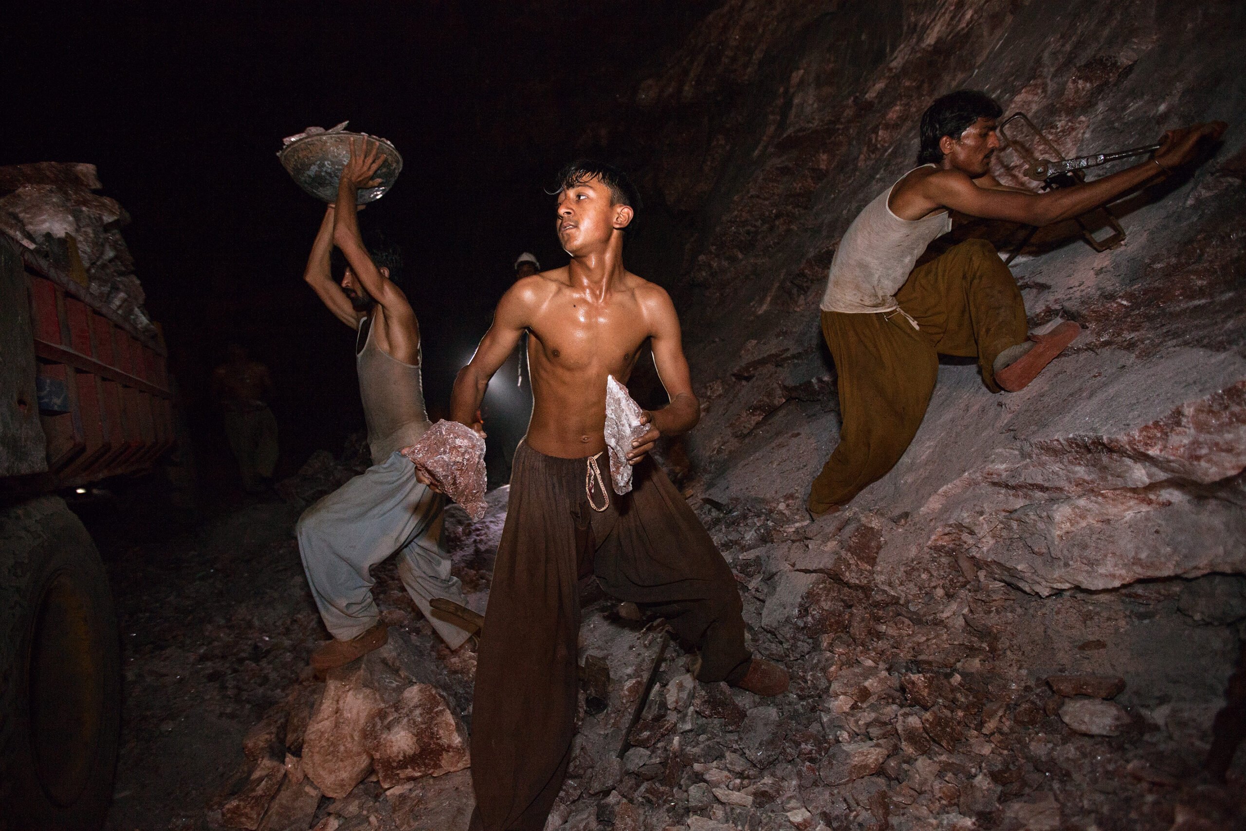 Three young men collecting salt rocks, photo by Luke Duggleby.