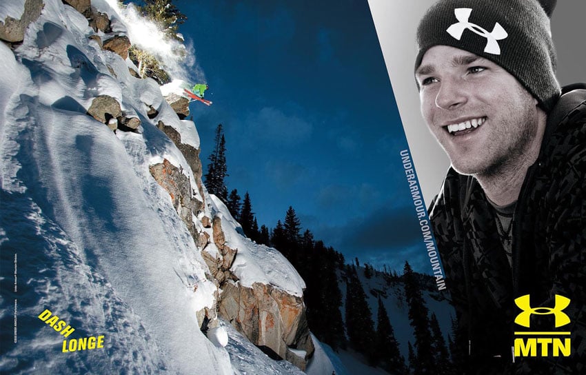 A tear sheet for Under Armour by Scott Markewitz featuring two photos of professional skier, Dash Longe. On the left is a photo of Dash skiing using orange skis and wearing a neon green jacket. He skis down a steep mountain that is rocky in the foreground.