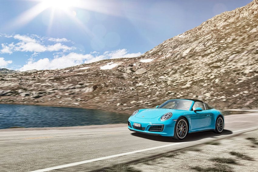 Elegant depiction of a Porsche in motion, gliding effortlessly down the open road. Photo by Stefan Jermann.