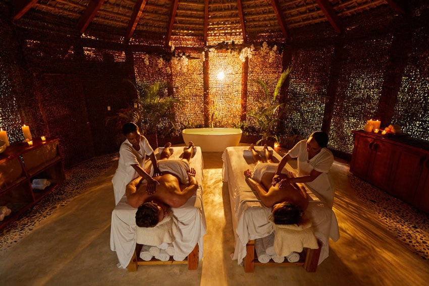 Immersed in a serene natural setting, a couple indulges in a blissful massage experience, photo by Steve Boxall.