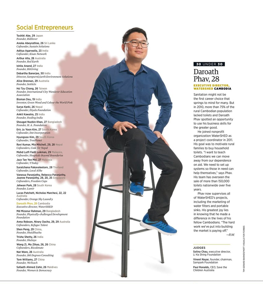 Tear sheet by photographer Tim Gerard Barker for Forbes Asia. The tear sheet features a portrait of Daroath Phav smiling while sitting on a tall stool. 