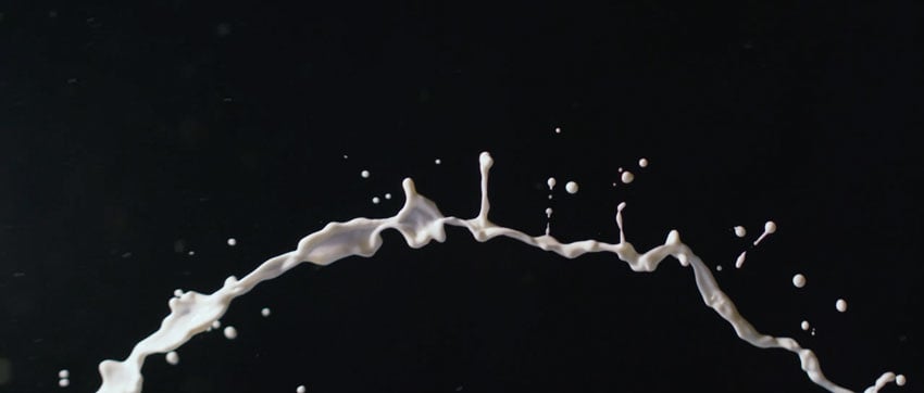 Cream flying across black background, shot by Will Strawser.
