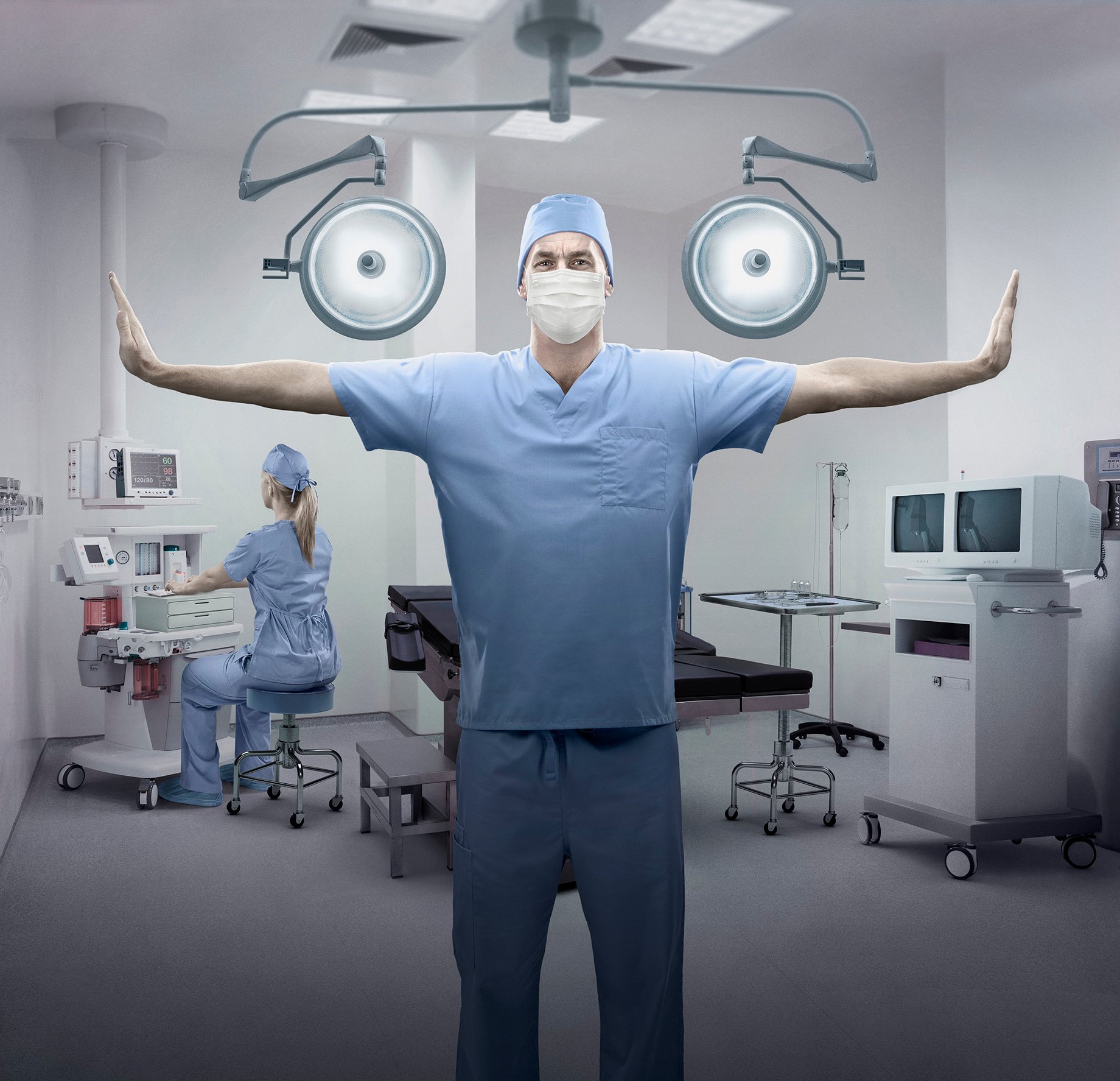 Hero image of surgeon with outstretched arms in wing shape shot by John Fulton for HondaJet Wings campaign.