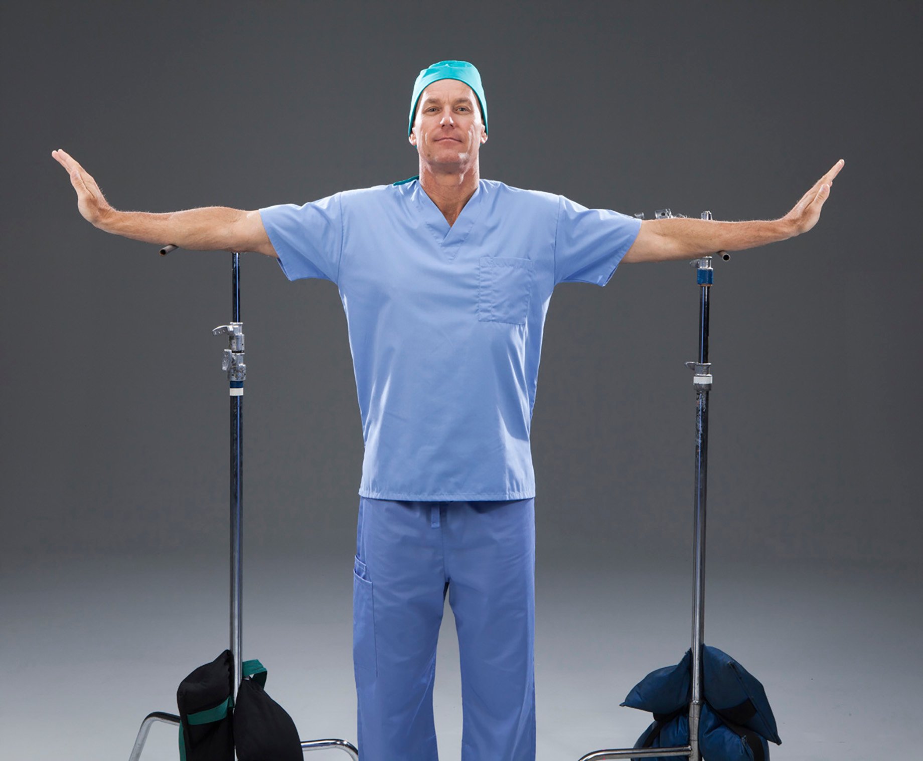 Studio shot of model portraying doctor using rests to keep arms up for wing shape shot by John Fulton for HondaJet Wings campaign.