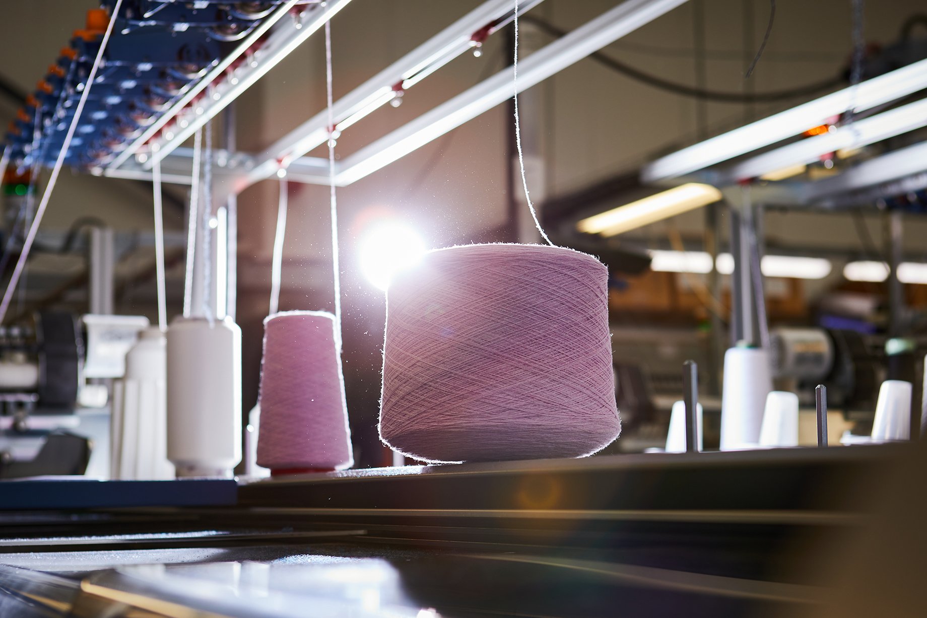 Fiber on spools at Albion Knitting Co. shot by Jackson Ray Petty for Peter Millar