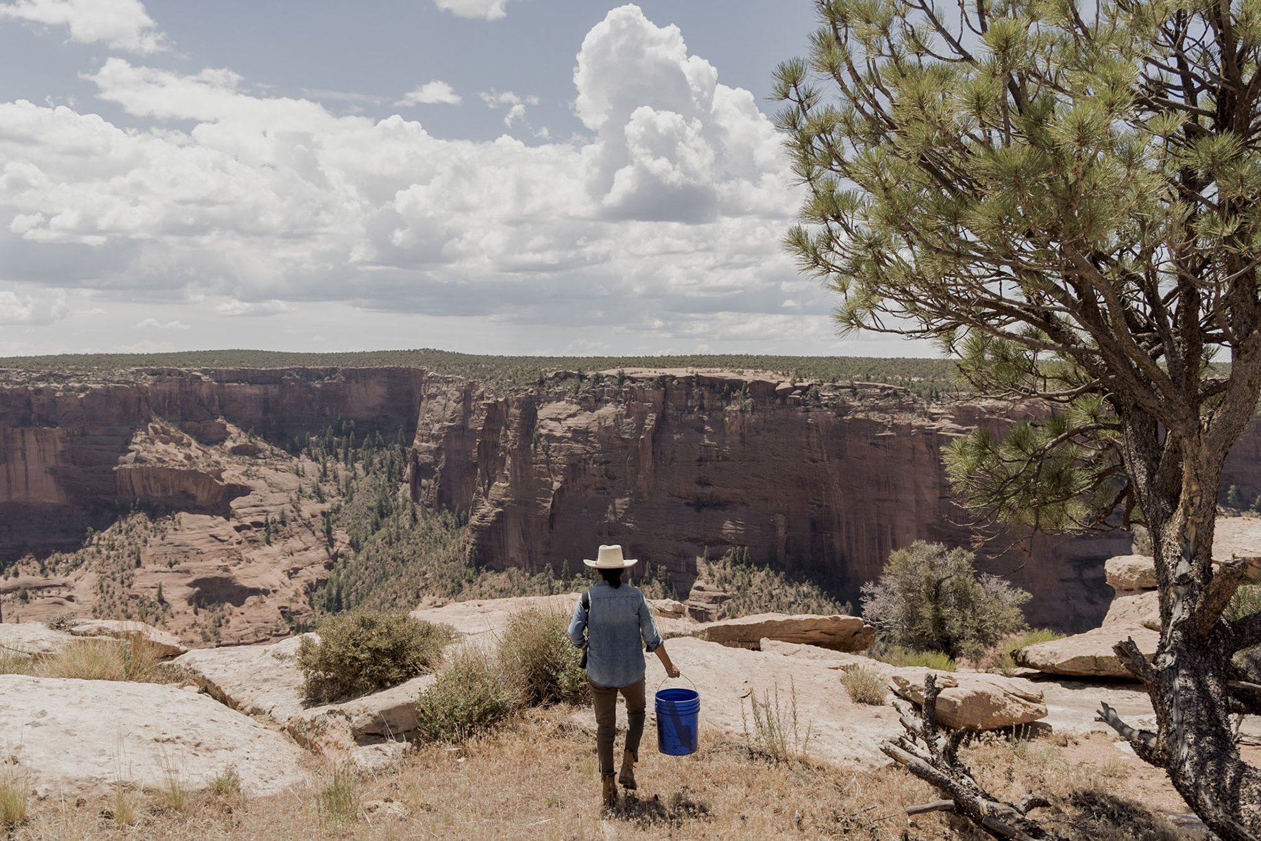 Missy Begay foraging for ingredients on the rim of Canyon de Chelly shot by Minesh Bacarina for Outside Magazine