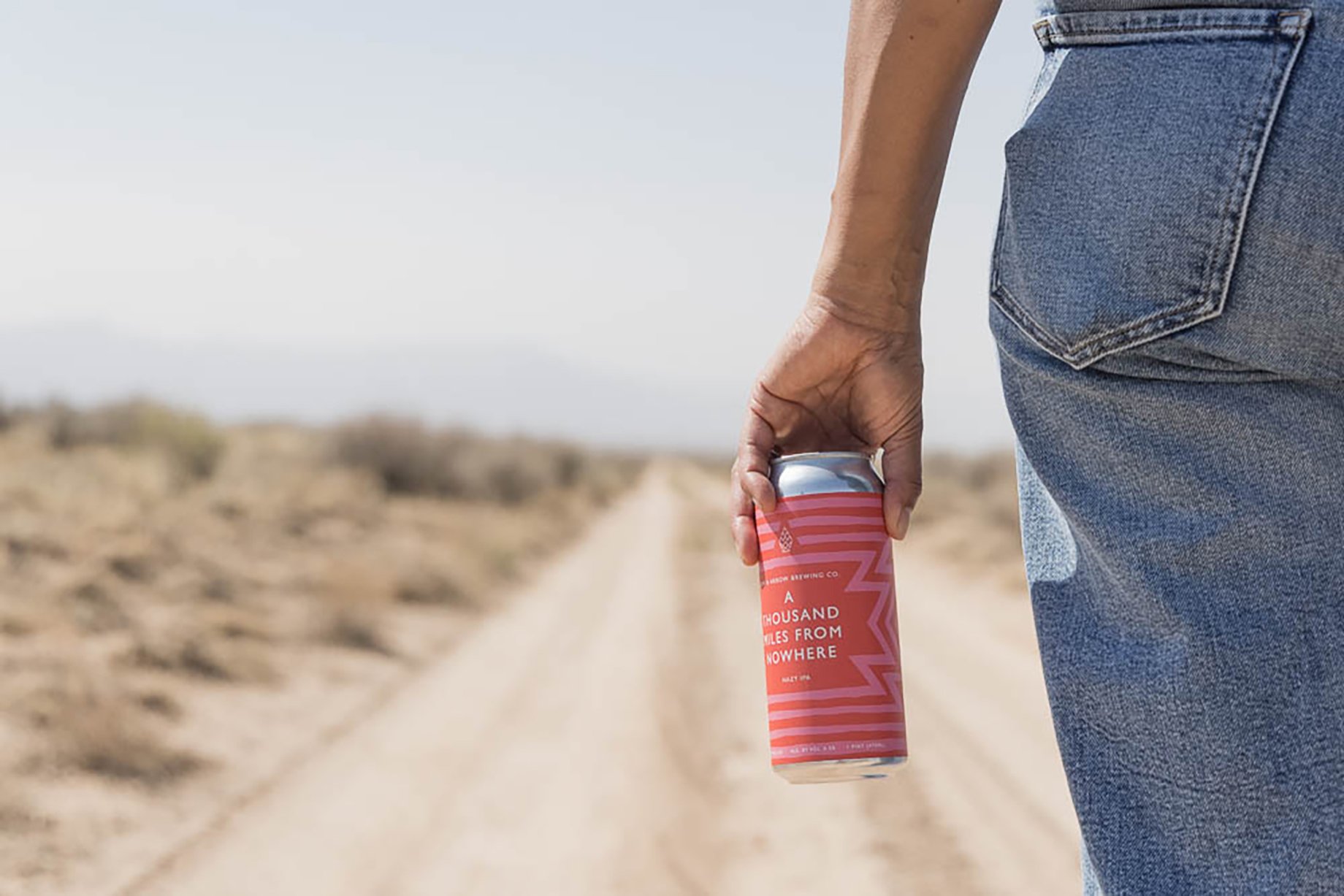Beer can from Bow & Arrow Brewery on a dirt road shot by Minesh Bacarina for Outside Magazine